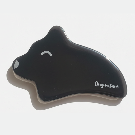 Black Gua Sha tool with 'Originature' branding on a white background